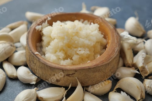 Preview: close up of minced garlic on a wooden spoon