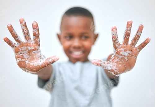 Preview: Shot of a little boy showing his hands after washing them at home