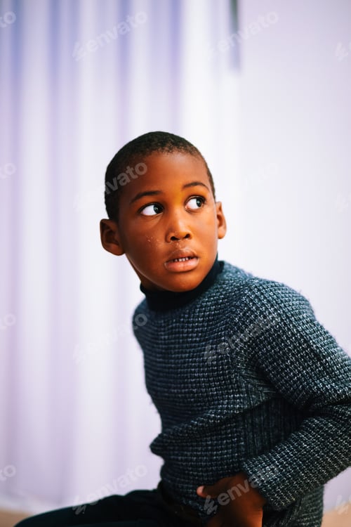 Preview: Young boy of color portrait looking away