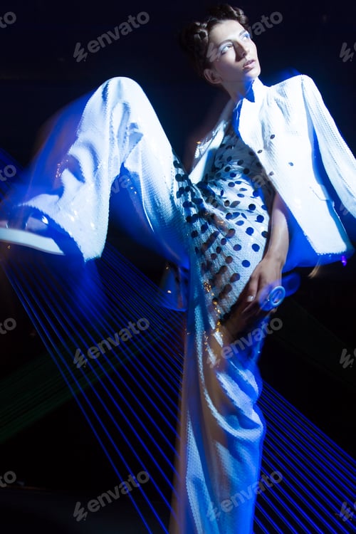 Preview: Fashion model in fashionable clothes in ultraviolet light