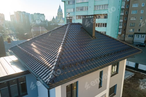 Preview: Aerial view of private house with ceramic shingles covered roof top.