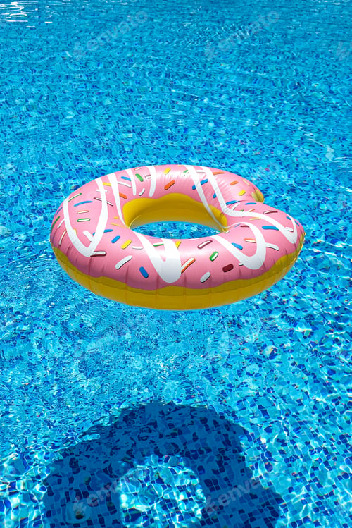 Preview: pink inflatable donut doughnut floating mattress in swimming pool. Beach pool accessories