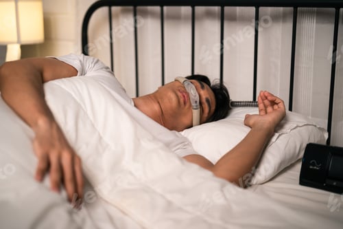 Preview: Asian man wearing cpap machine sleeping smoothly all night in bedroom.