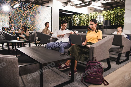 Preview: group of multicultural businesspeople working at modern coworking office