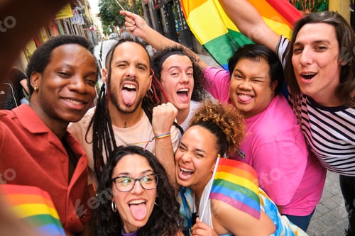Preview: A group of LGBTQ people taking a selfie with rainbow flags during Pride Parade.