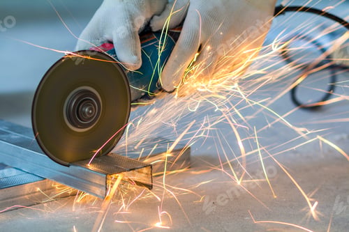 Preview: Close-up of worker cutting metal with grinder. Sparks while grinding iron