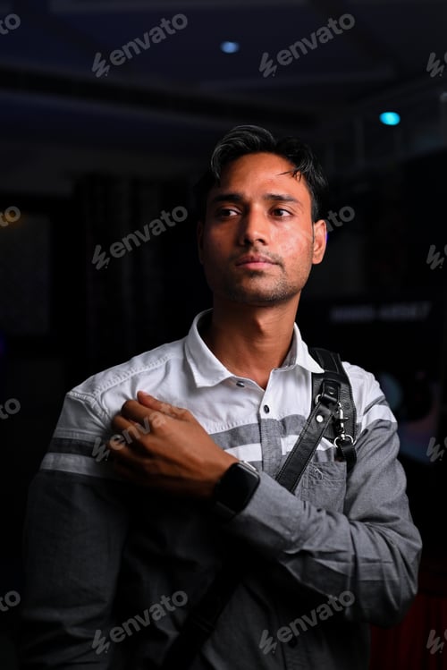 Preview: Indian photographer carrying cameras during an event
