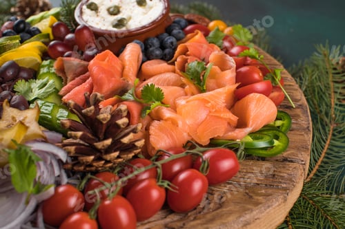 Preview: Christmas food Antipasto. Smoked salmon and vegetables with olives at serving board.