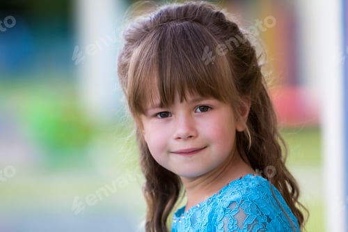 Preview: Portrait of little fashionable blond girl in blue dress, with gray eyes and beautiful long hair