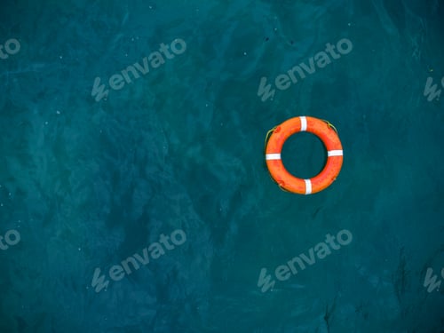 Preview: Top view of lifebuoy in the sea. Life ring floating in a sea.