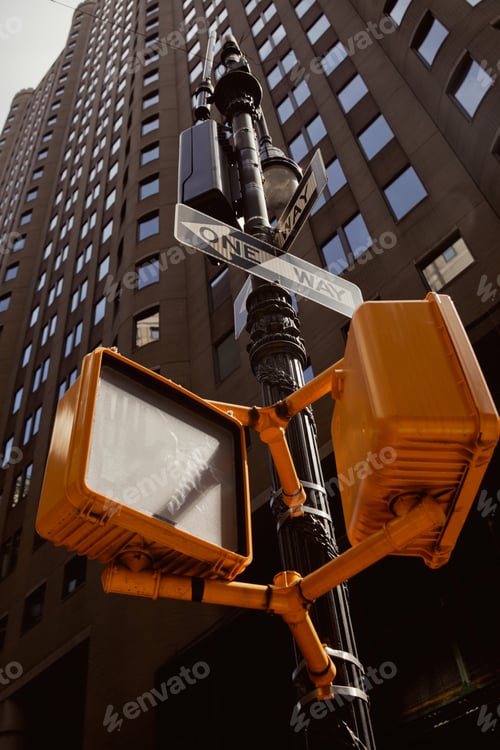 Preview: street pole with traffic lights and road signs near modern building in new york city, low angle view