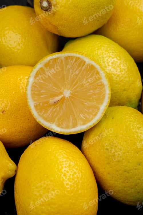 Preview: side view of fresh ripe lemons on black background