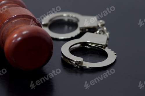 Preview: The gavel represents the authority to make decisions, while the handcuffs signify the potential