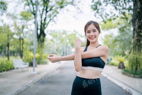 Preview: Portrait of young woman in fitness wear exercising in park. Healthy Concept.