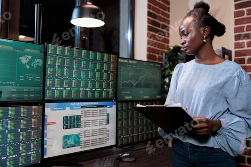 Preview: Forex stock market agent standing in front of multi monitor workstation.