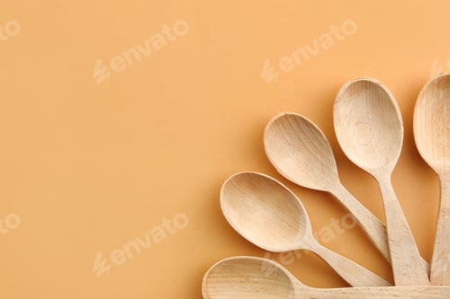 Preview: Flat lay composition with clean wooden spoons and space for text on color background