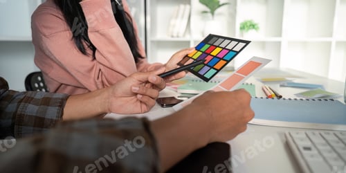 Preview: Design team meeting on color charts and graphics in a bright office for effective collaboration