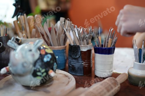 Preview: Young Woman hand potter making clay vase in pottery workshop, Business owner.