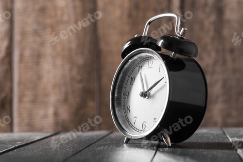 Preview: Alarm clock on an old wooden table