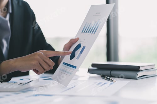 Preview: Two businessman investment consultant analyzing company financial report balance working with docume