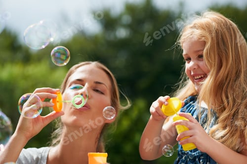 Preview: Making lifelong memories together. Shot of a young mother blowing bubbles with her daughter.