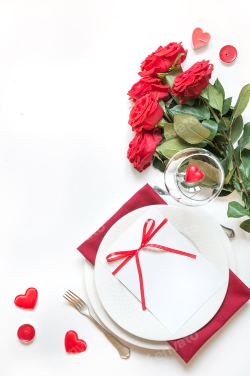 Preview: Valentine's day dinner. Romantic table setting with red roses. View from above.