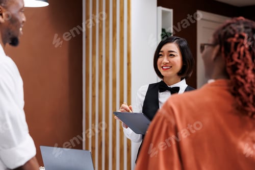 Preview: Asian woman writing check in form
