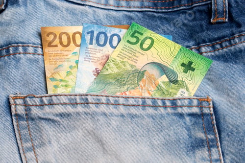 Preview: Swiss franc in the pocket of blue jeans