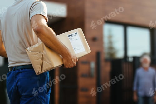 Preview: Unrecognizable courier making a home delivery.