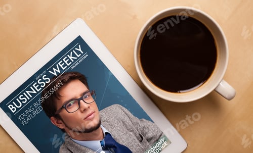 Preview: Workplace With Tablet Pc Showing Magazine Cover And A Cup Of Coffee On A Wooden Work Table Close-Up