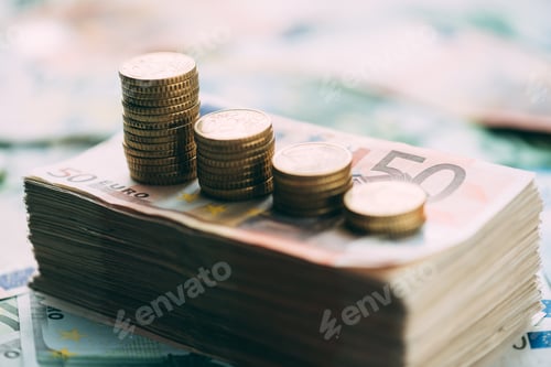 Preview: Euro coins on cash stack closeup