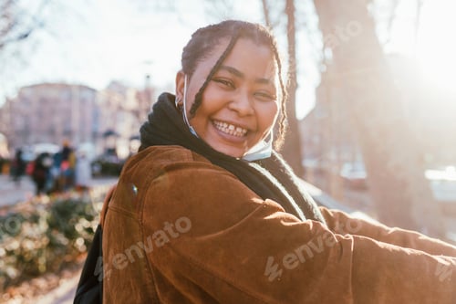 Preview: Portrait of smiling young woman outdoors