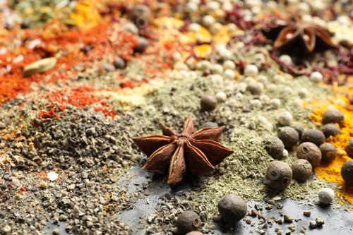 Preview: Many different spices on dark table, closeup
