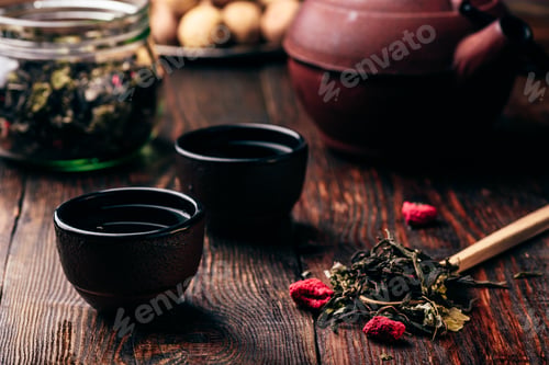 Preview: Tea bowls with teapot and spoonful of raspberry herbal tea