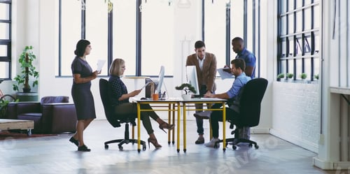 Preview: Full length shot of a group of designers working together in their creative office