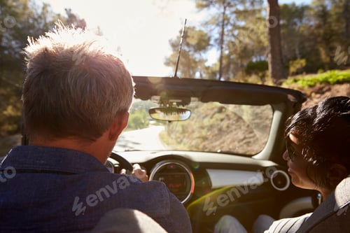 Preview: Couple driving in open top car, rear passenger point of view