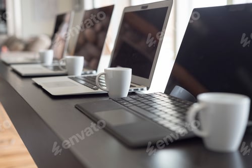 Preview: Laptop computers with coffee cups