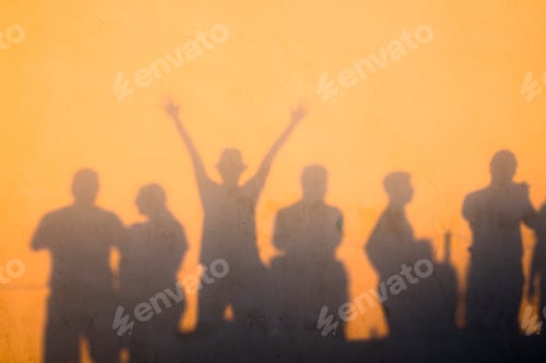 Preview: Shadows of people at sunset on a wall