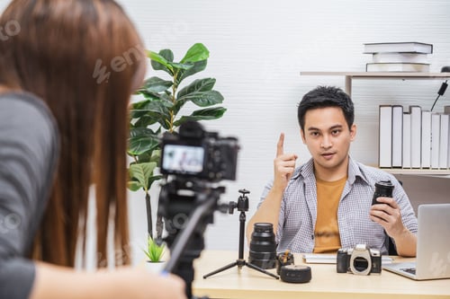Preview: Camera taking video and live with laptop of Asian Vlogger man satisfied the camera lens each media