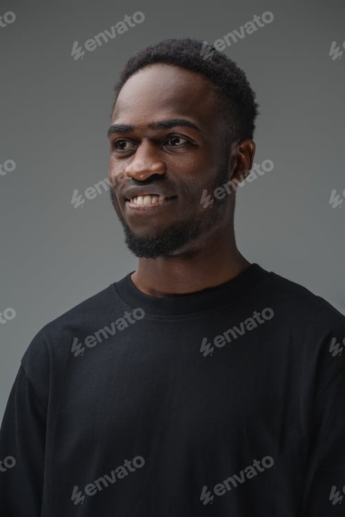 Preview: Joyful african man with black shirt against grey background