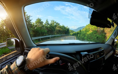 Preview: People driving car on sunrise mountain road
