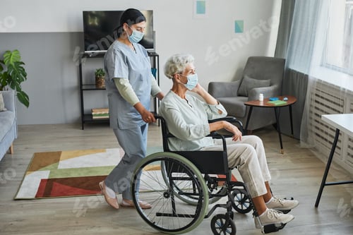 Preview: Caregiver Assisting Senior in Wheelchair