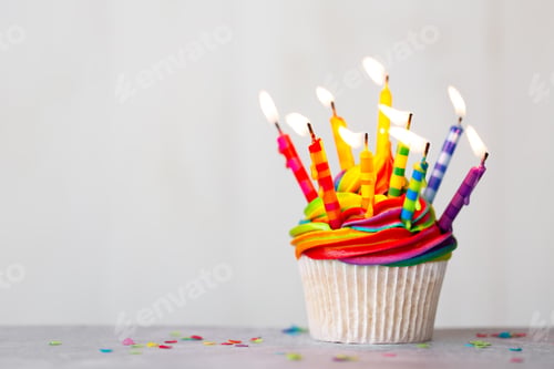 Preview: Birthday cupcake with rainbow frosting and candles