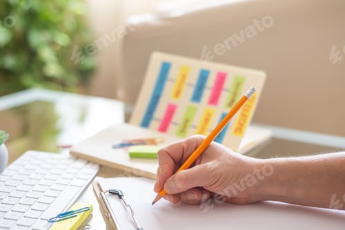 Preview: Teacher writing on clipboard while planning school activities, education and successful learning