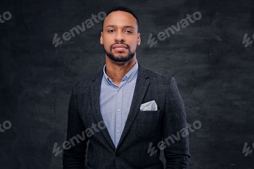 Preview: Studio portrait of elegant black male dressed in a suit.