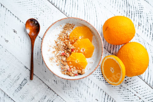 Preview: Top view breakfast with oatmeal,orange and Granola