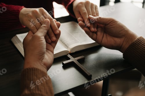 Preview: Two people reading and study bible in home and pray together.Studying the Word Of God With Friends.