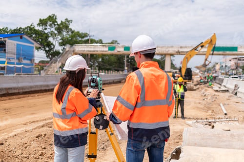 Preview: Engineers Surveyor wearing safety uniform ,helmet with equipment theodolite to measurement positioni
