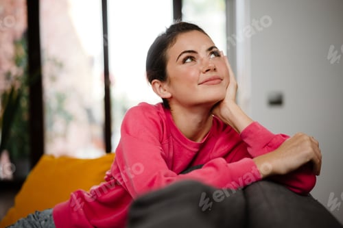 Preview: Dreamy attractive woman relaxing on a couch