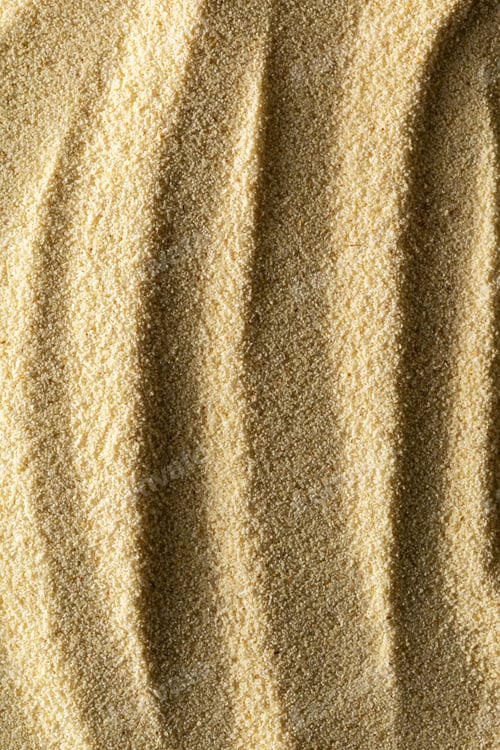 Preview: vertical sandy light background format 2:3 with waves of sand macro